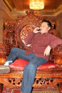 man in china chair vaping