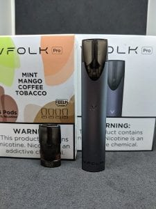 VFolk device and pod in front of boxes