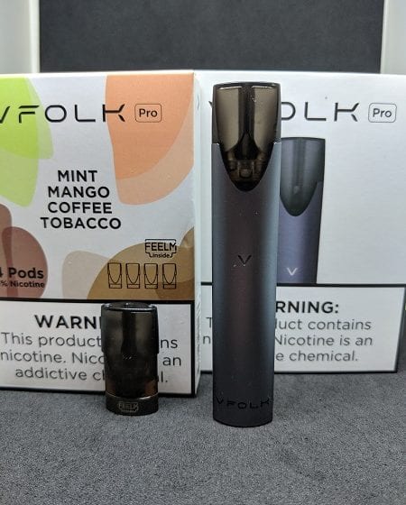 VFolk device and pod in front of boxes