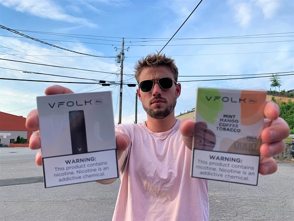 Man holding VFolk product boxes
