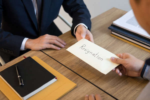 businessman hand sending a resignation letter to executive boss