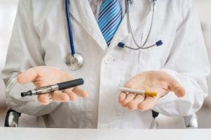 Doctor is comparing electronic vaporizer and conventional tobacc
