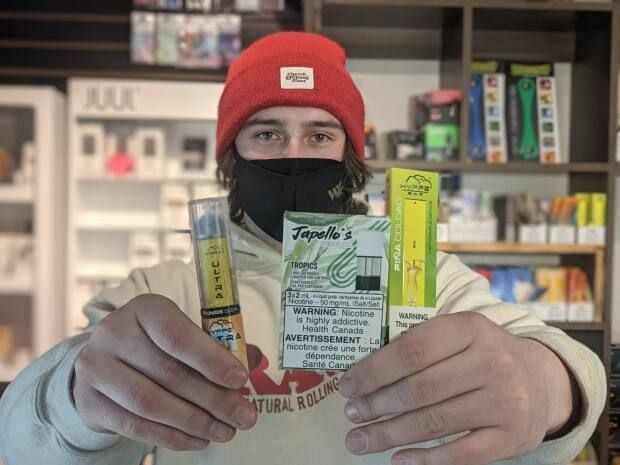 man holding flavored vape products